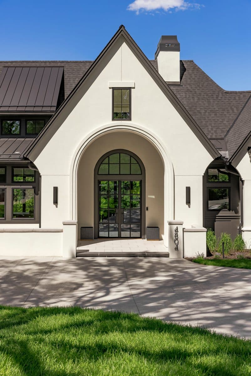 Luxury home exterior with architectural entry — security and surveillance integration