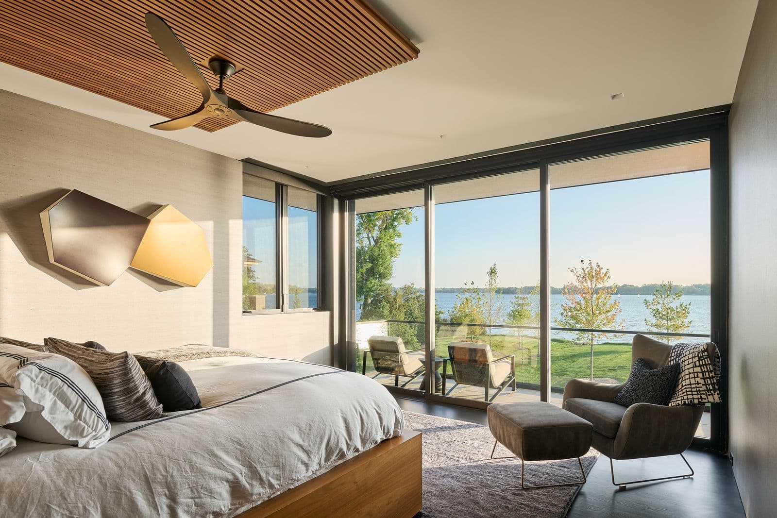 Master bedroom with automated motorized roller shades and lakefront views