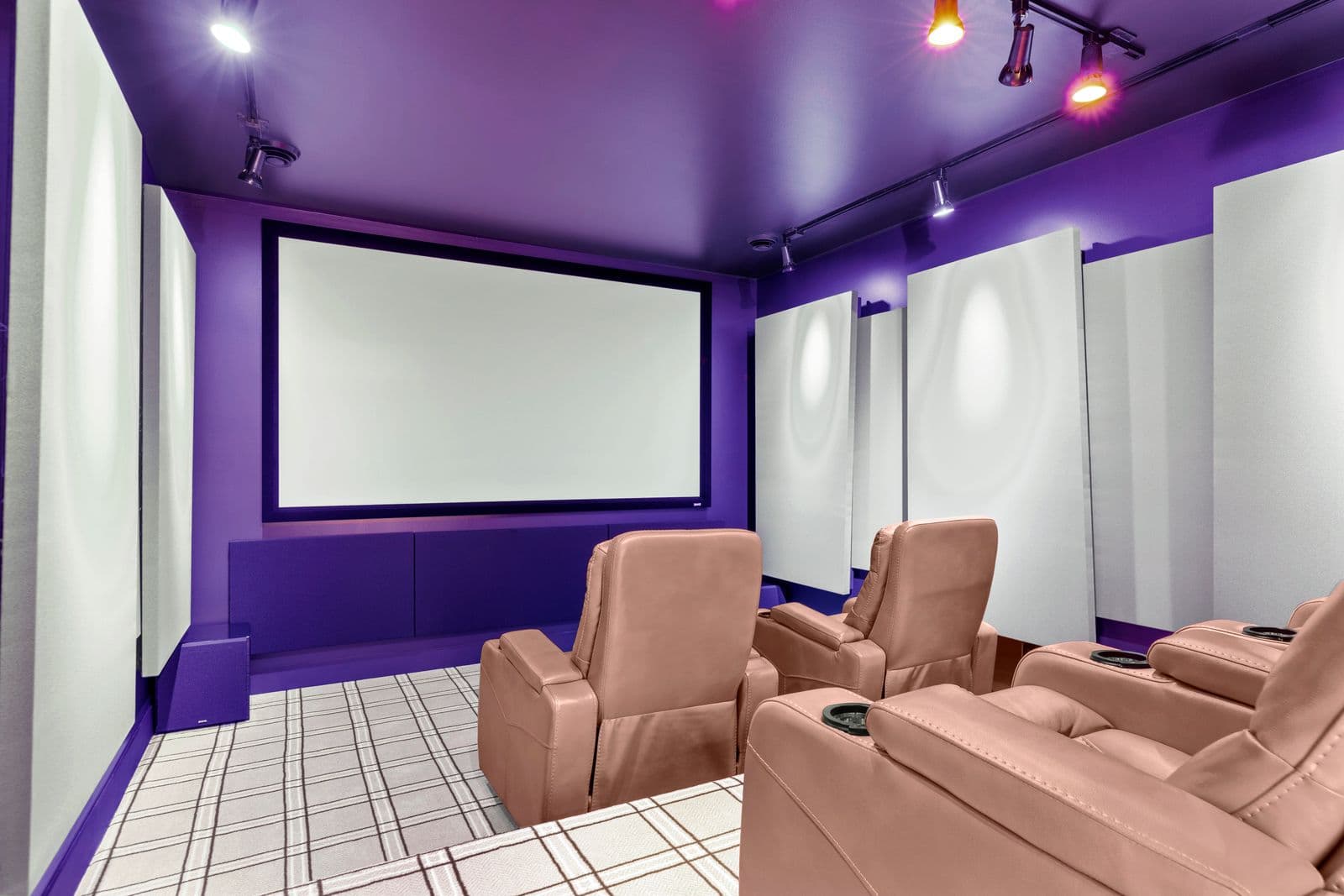 Purple-walled home theater with projection screen and reclining seats