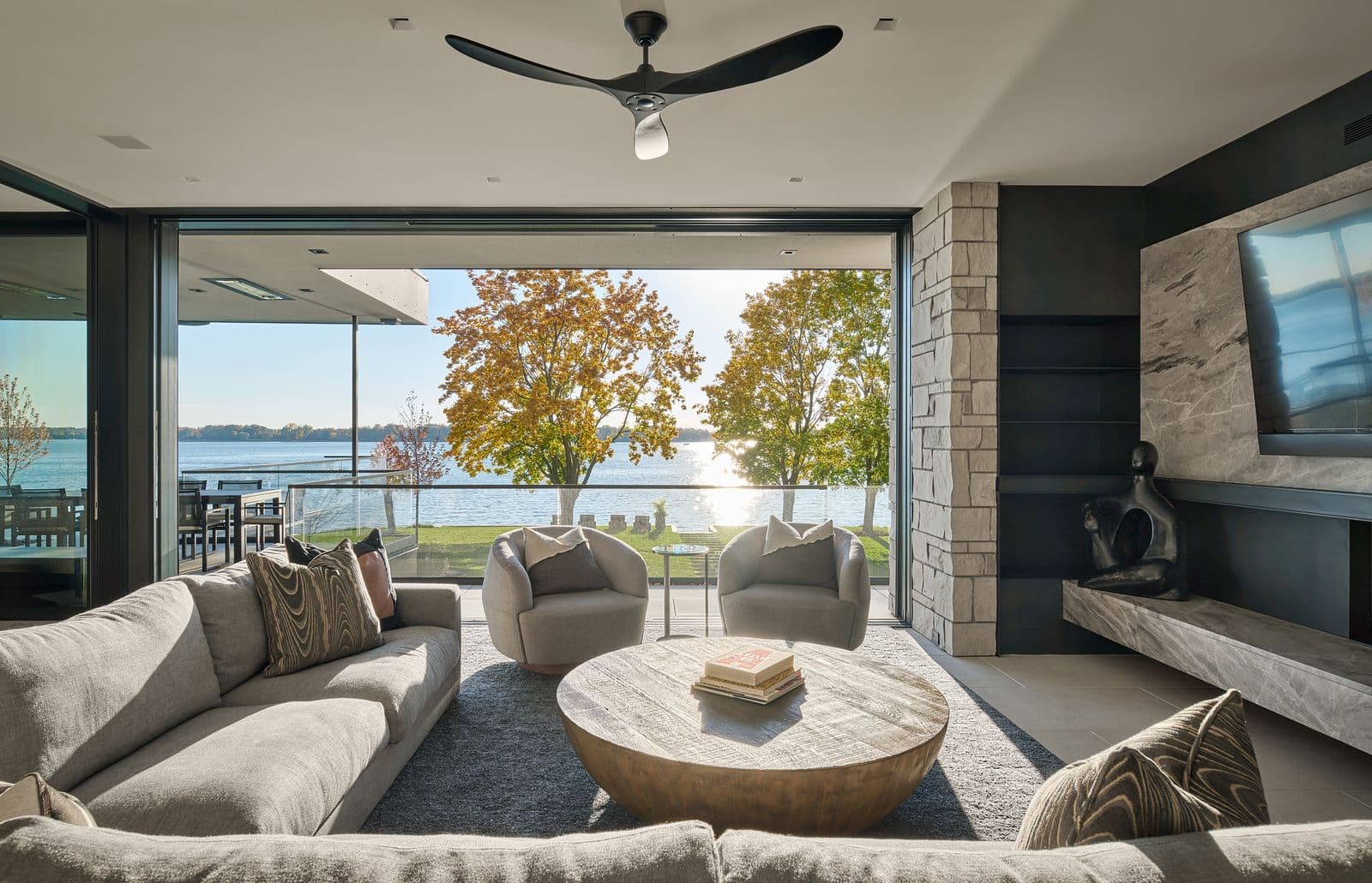 Lakefront living room with distributed audio and wall-mounted display