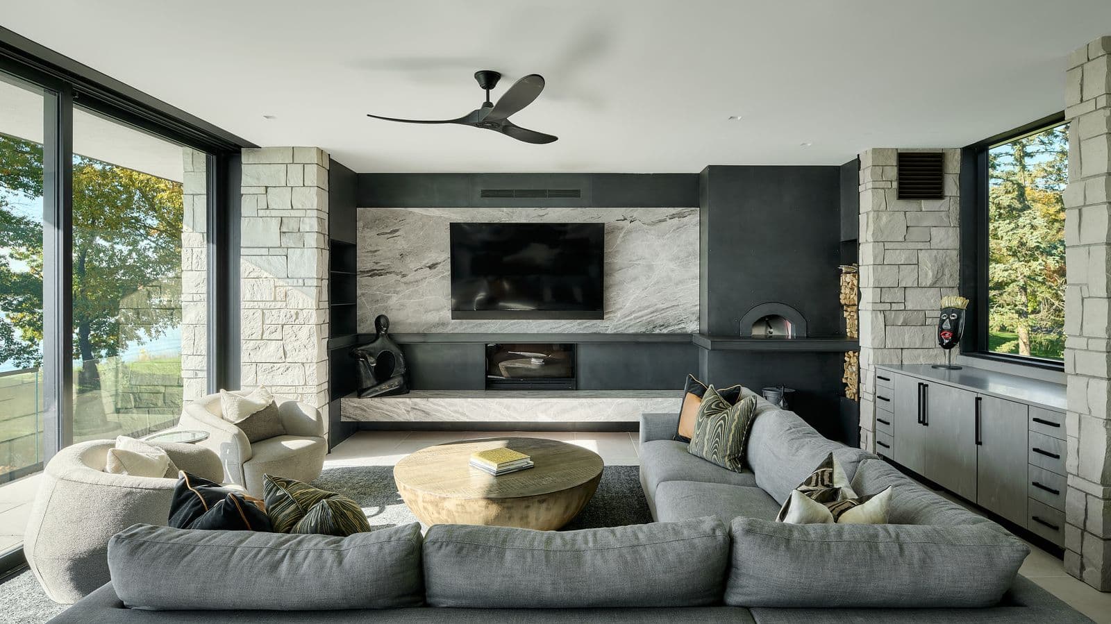 Living room with integrated in-wall speakers and flush-mounted display