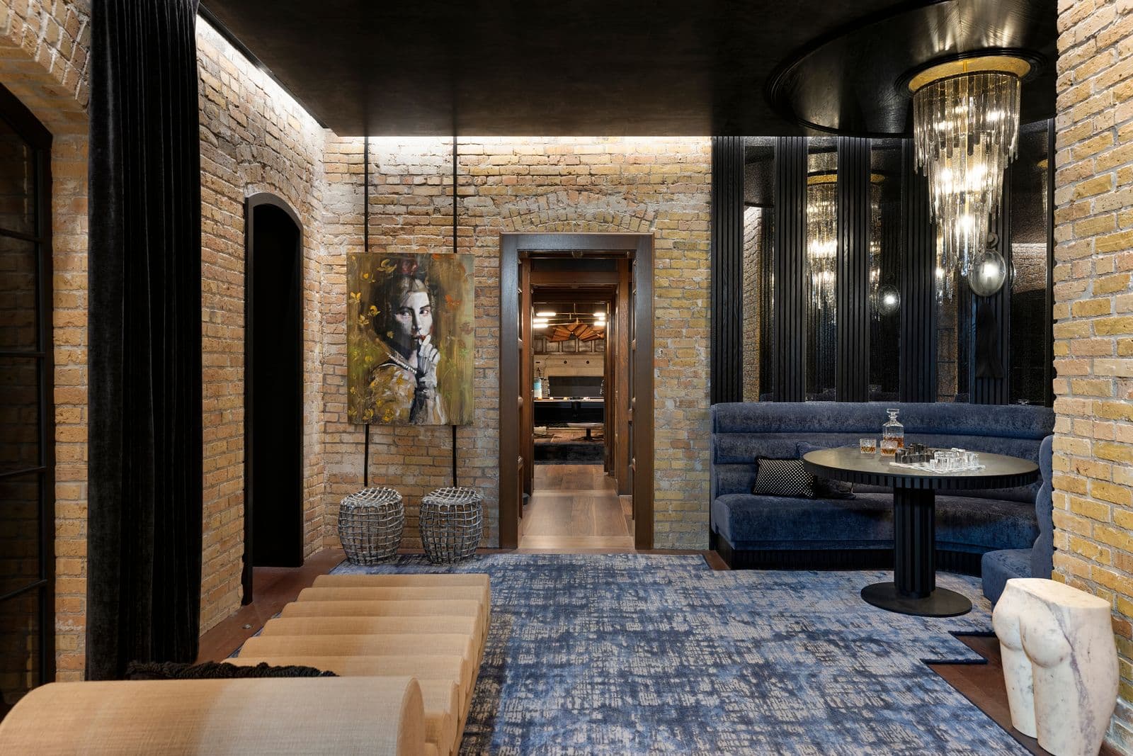 Luxury home theater lounge with brick walls and velvet seating